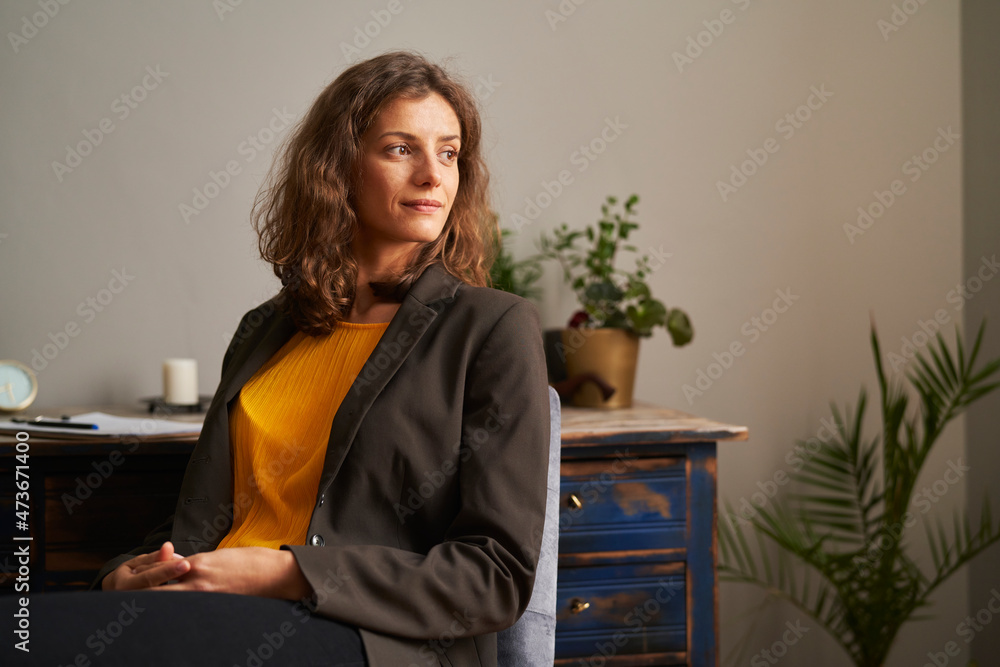 A portrait of psychotherapist in her cabinet.