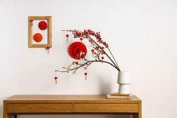 Table with beautiful decorations for Chinese New Year celebration in room