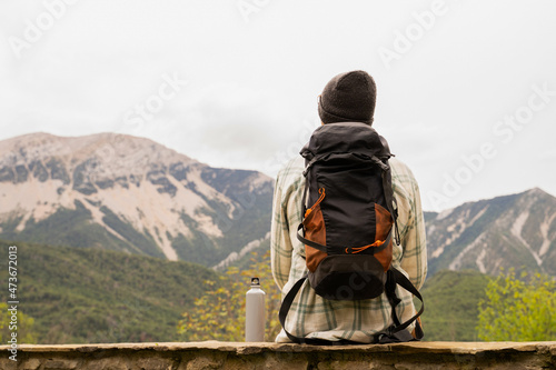 Backpacker overlooking the mountain range photo