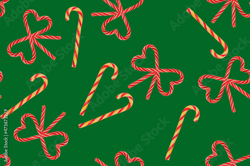 seamless pattern of Christmas candies on a green background