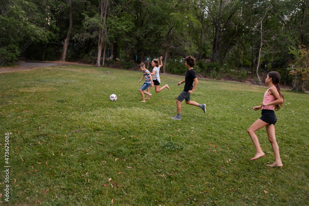 Kids playing casual soccer game Kids playing casual soccer game