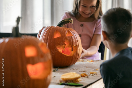 Girl Shows Off Jack-O-Lantern photo