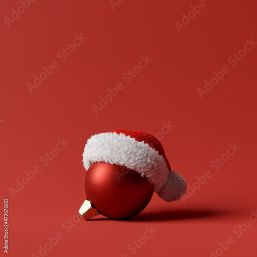 Christmas ball with santa hat on red background. creative idea. Christmas concept. 3d rendering photo