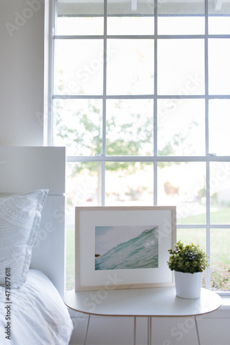Bright, neutral bedroom with framed art