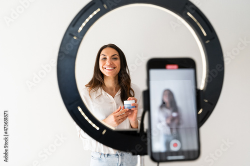 Young woman recording video blog at home photo