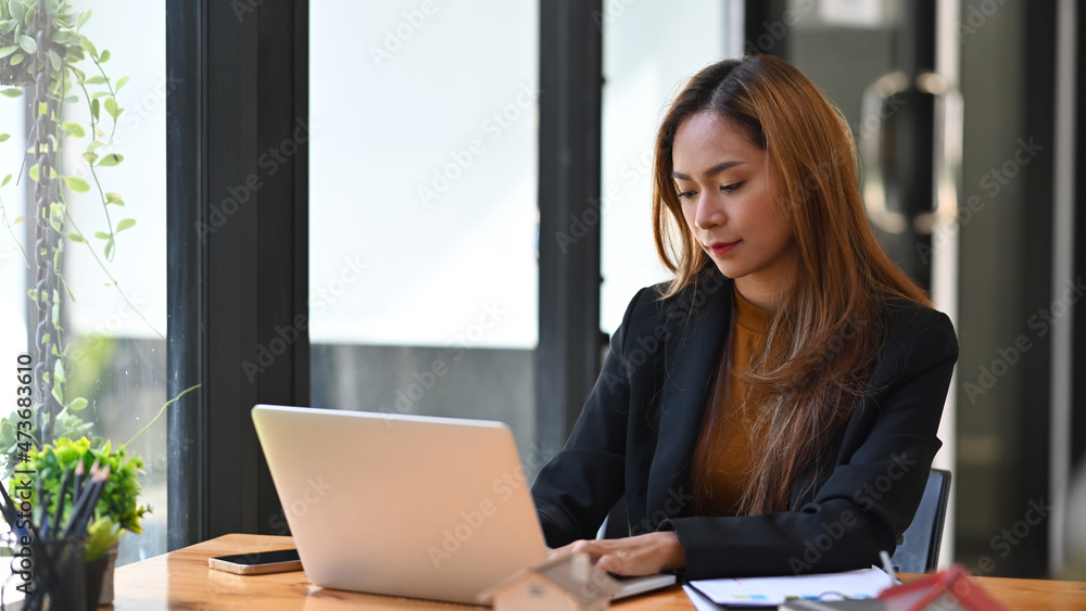 Asian business woman concentrated working on computer laptop. Asian business woman concentrated working on computer laptop.