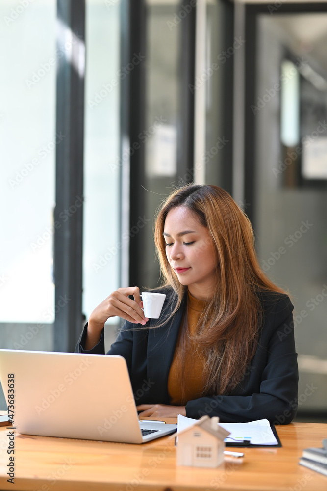 Portrait of confident businesswoman drinking coffee and working in modern office. Portrait of confident businesswoman drinking coffee and working in modern office.