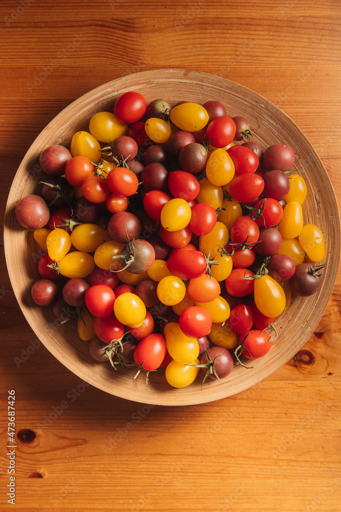 cherry tomatoes on the round wooden dish cherry tomatoes on the round wooden dish