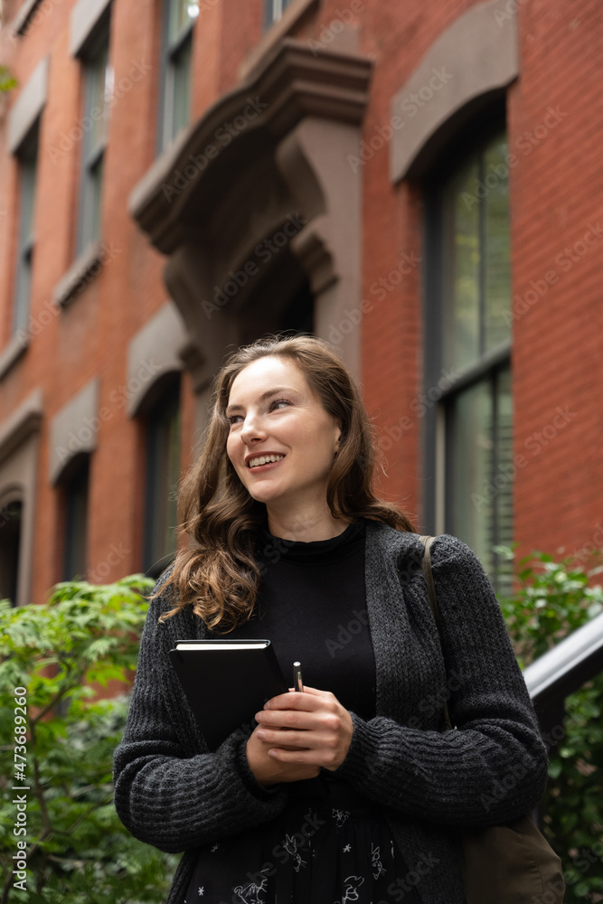 Smiling young woman with notebook Smiling young woman with notebook