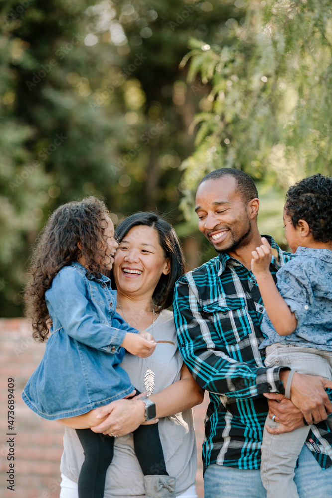 Laughing diverse family outdoors Laughing diverse family outdoors