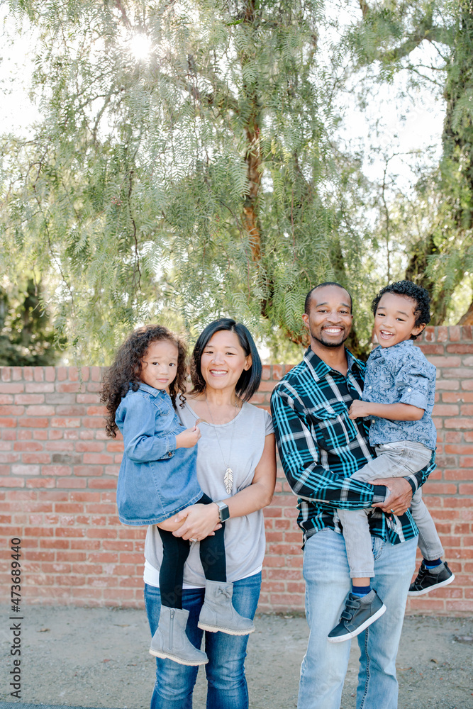 Diverse family with young children outdoors Diverse family with young children outdoors