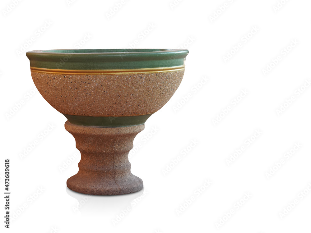 beautiful antique green and gold stone pot on brown stone saucer on white background, object, copy space beautiful antique green and gold stone pot on brown stone saucer on white background, object, copy space