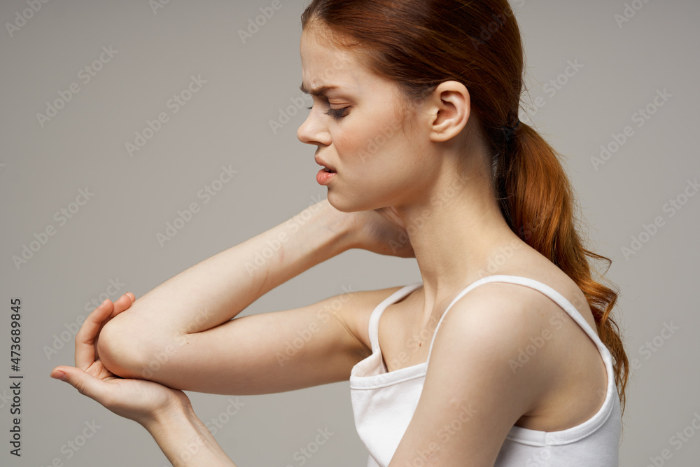 woman in white t-shirt rheumatism elbow pain health problems light background woman in white t-shirt rheumatism elbow pain health problems light background
