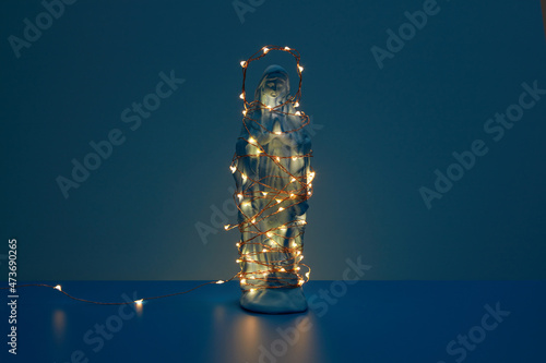 Virgin Mary statue with glowing garland