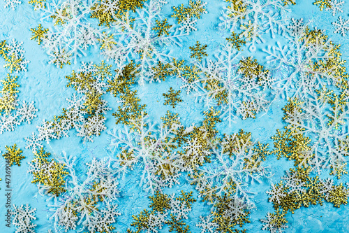 christmas blue background with white and gold large and small snowflakes