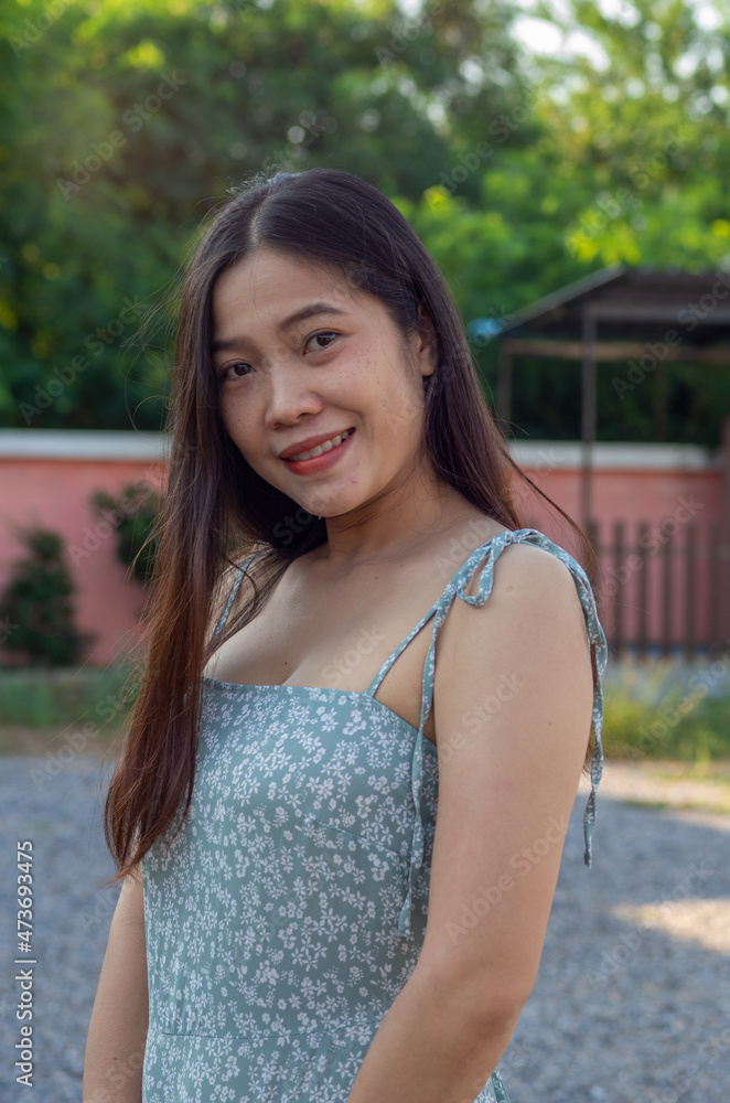 a Asian nationality Thai woman wearing blue dress and feel good a Asian nationality Thai woman wearing blue dress and feel good