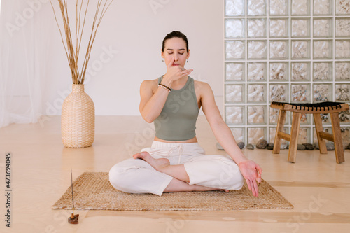 Woman Doing Breathing Exercise Before Yoga photo