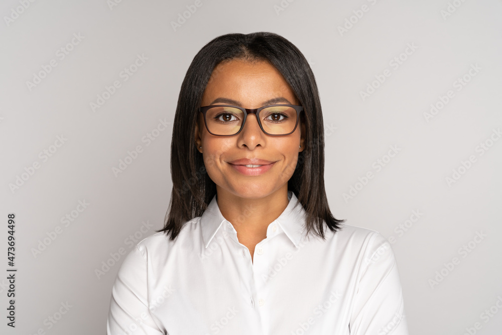 Portrait of successful african worker employee wearing glasses and happy smiling isolated over studio wall. Confident black businesswoman or entrepreneur demonstrate success and leadership concept Portrait of successful african worker employee wearing glasses and happy smiling isolated over studio wall. Confident black businesswoman or entrepreneur demonstrate success and leadership concept