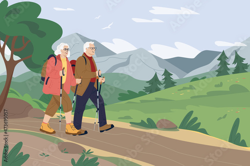 Happy active senior couple traveling together with backpacks and trekking sticks on holidays. Hiking. Enjoying nature, having a good time on their retirement