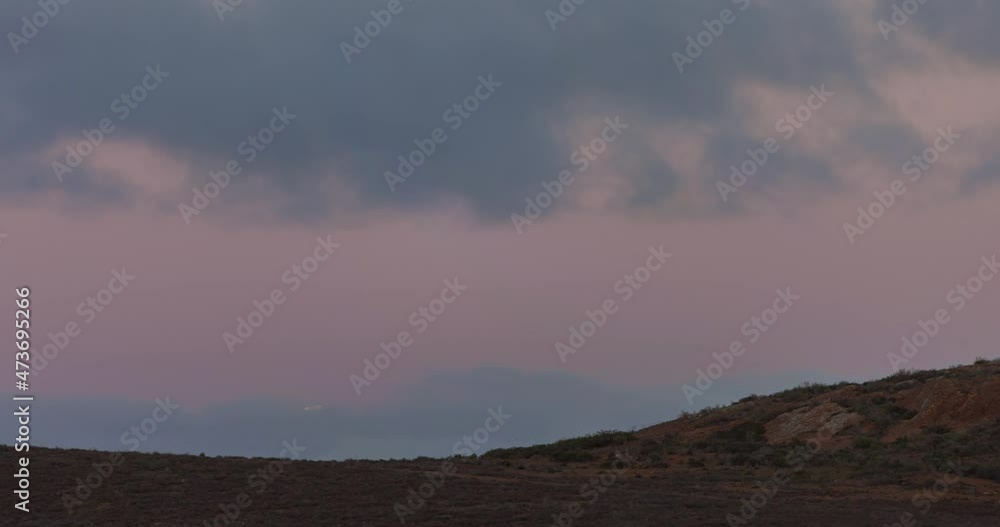 Time Lapse Lockdown Shot Of Full Moon Moving Amidst Clouds In Sky - Baja California, Mexico Time Lapse Lockdown Shot Of Full Moon Moving Amidst Clouds In Sky - Baja California, Mexico