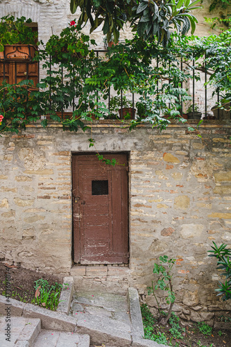 Small door on stone house photo