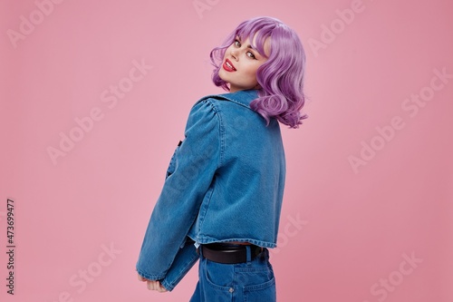 Young woman wavy purple hair blue jacket emotions fun color background unaltered photo