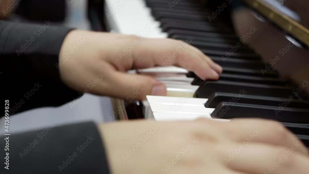 Close-up of male hands playing the piano Close-up of male hands playing the piano
