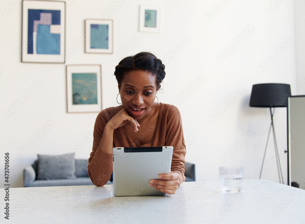 Happy woman using her digital tablet at home Happy woman using her digital tablet at home