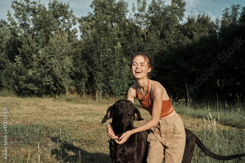 cheerful woman outdoors with dog and fun nature © VICHIZH