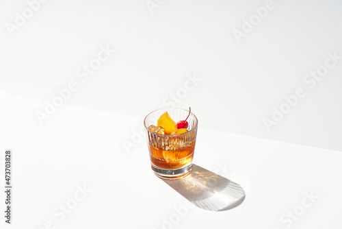 Glass of old fashioned cocktail photo