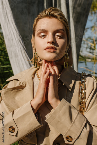 A  girl in a headscarf and accessories folded her arms photo