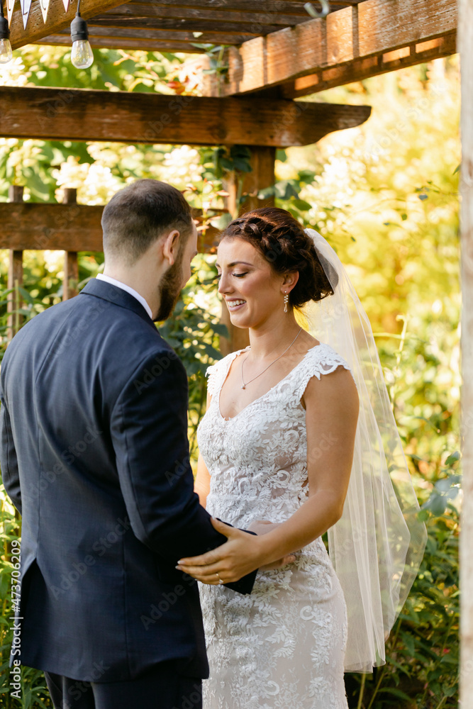 Happy Bride and Groom Standing under Arbor Happy Bride and Groom Standing under Arbor
