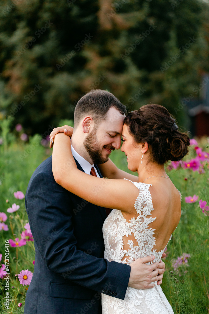 Smiling Bride and Groom in Field of Flowers Smiling Bride and Groom in Field of Flowers