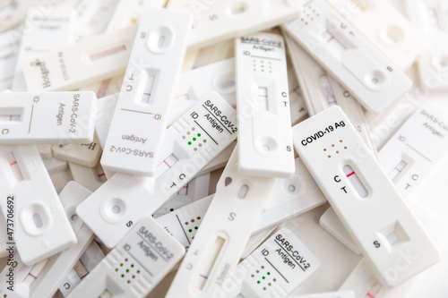 Pile of Covid Rapid antigen tests on white background