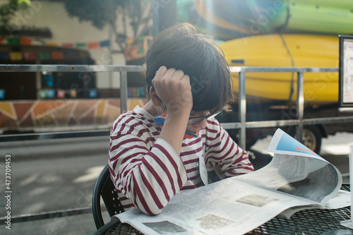 Teen reading periodical at street parklet