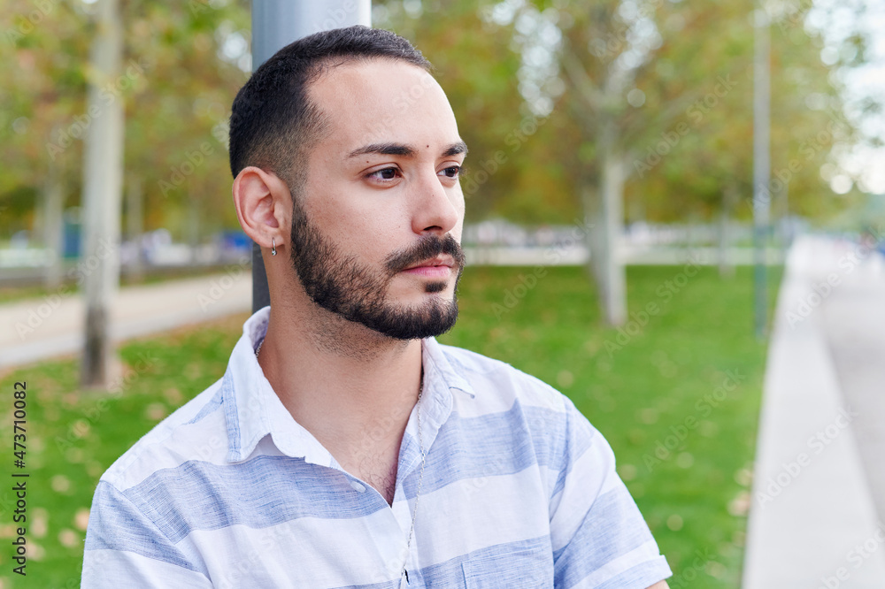 Smiling young man standing in a park Smiling young man standing in a park