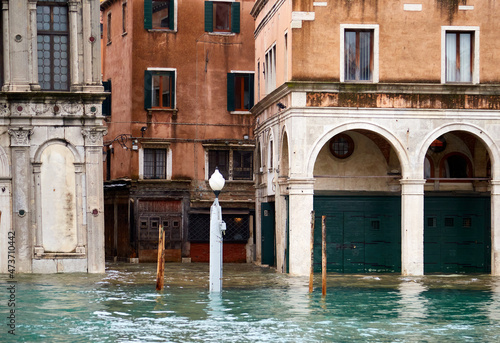 Flooded canal architecture in Venice aqua alta photo