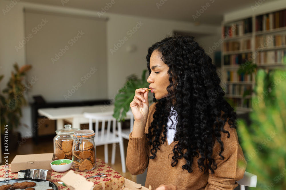Woman eating cookies in Christmas Woman eating cookies in Christmas
