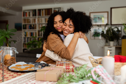 Women hugging in Christmas at home