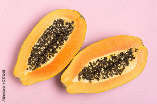 Papaya on pink background, top view, copy space 