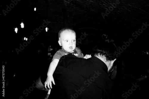A  toddler boy with his father at night photo