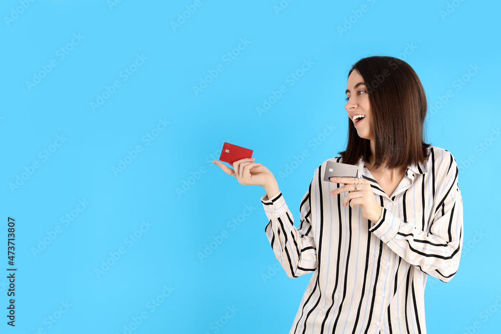 Attractive woman with cards on blue background Attractive woman with cards on blue background