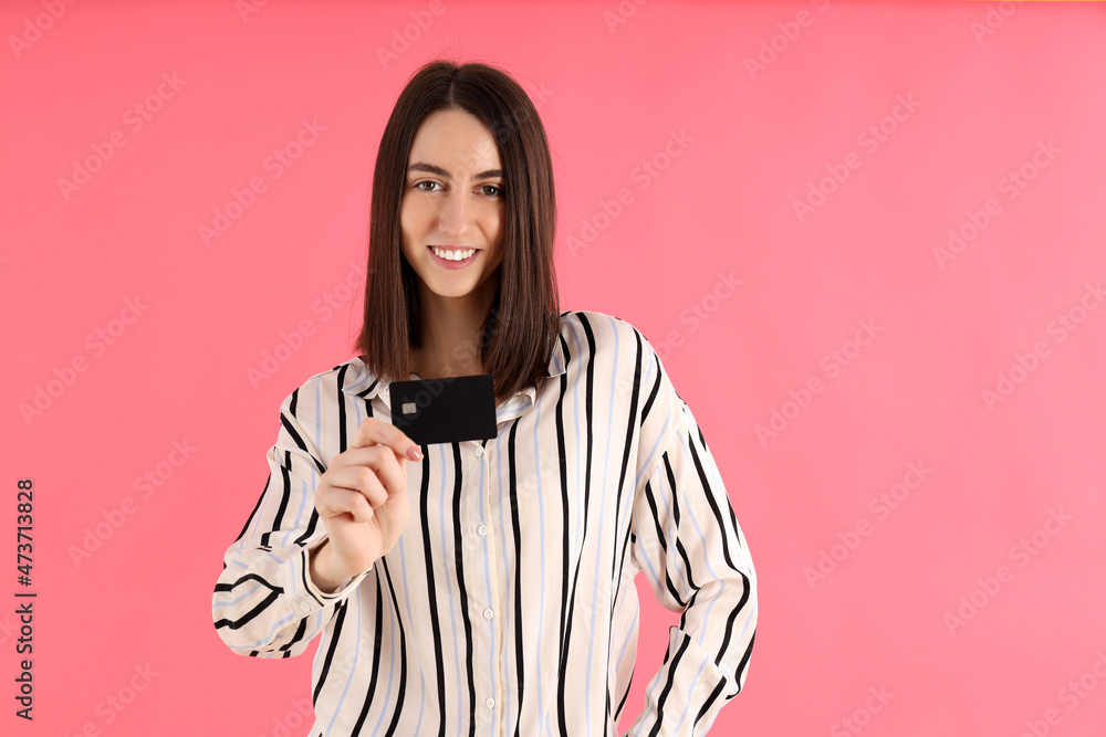 Attractive woman with card on pink background Attractive woman with card on pink background
