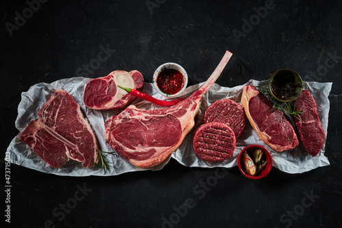 Konstfotografi Raw beef steaks and cutlets with chili pepper and spices