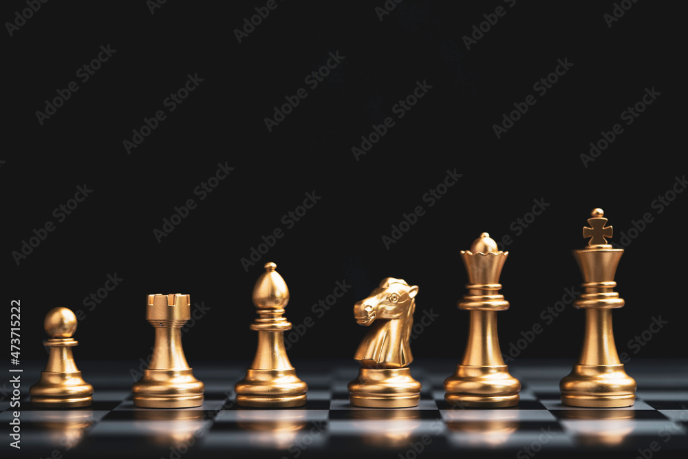 Golden chess include king queen horse ship and pawn on dark background. Golden chess include king queen horse ship and pawn on dark background.