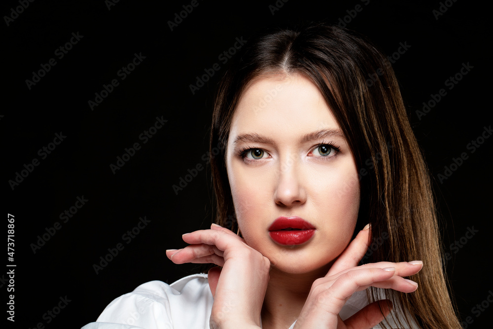 Beautiful girl model with red sensual lips on a black background. Beautiful girl model with red sensual lips on a black background.