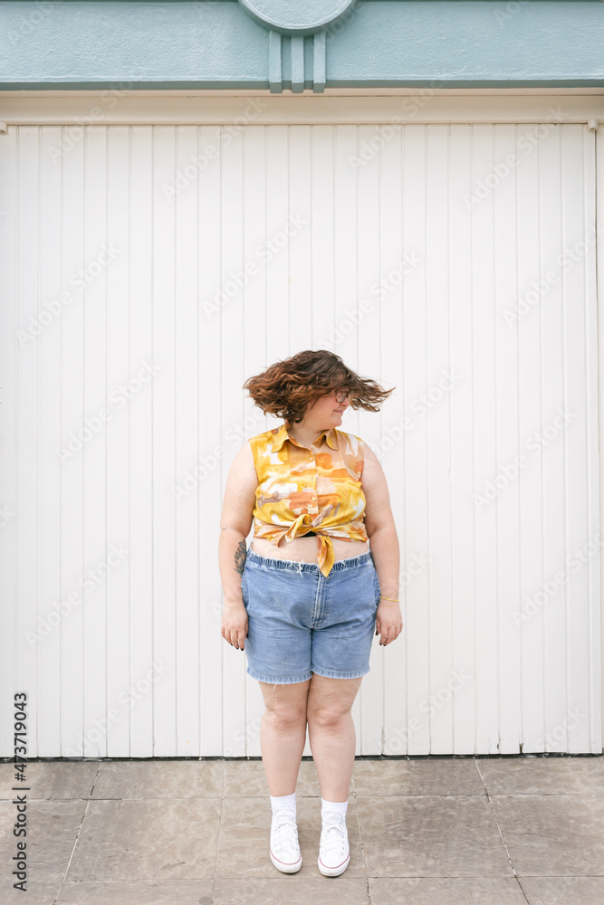 Young woman having fun in front of a white wall Young woman having fun in front of a white wall