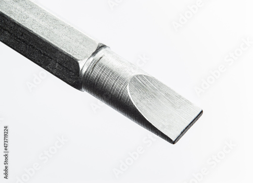 Standard tip Screwdriver close up over size image on white background. Show texture and detail from metal turning processs.