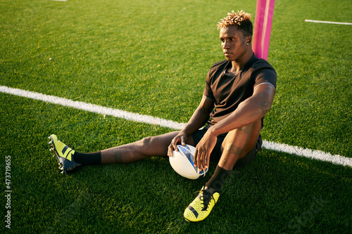 Black rugby player on sports field photo