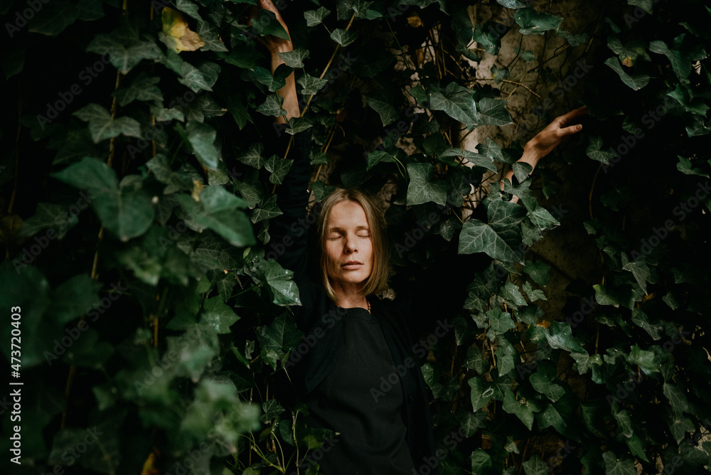 portrait of a young woman in green leaves portrait of a young woman in green leaves